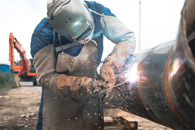 People working on metal structure welding