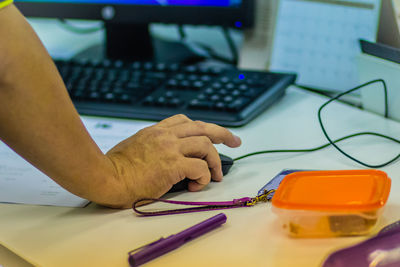 Man using computer mouse on table