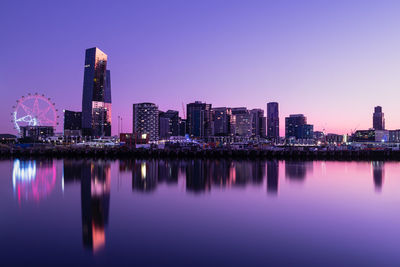 Reflection of illuminated buildings in city