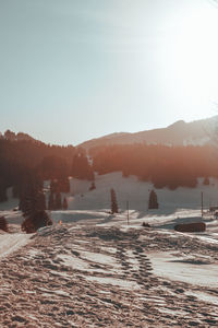 Scenic view of snowcapped mountains against sky during sunset