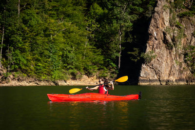 Boat on river against trees