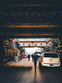 Rear view of man on woman moving in city at night