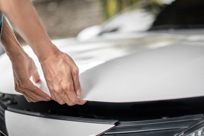 Close-up of hands on car