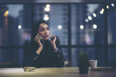 Young woman sitting on table