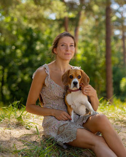 A woman on a walk with a beagle dog. training and walking in nature with a pet