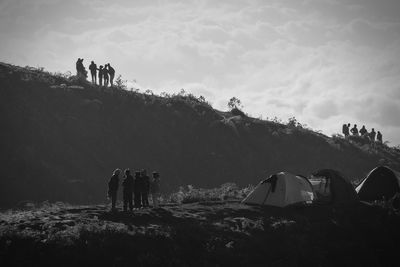 People in tent against sky