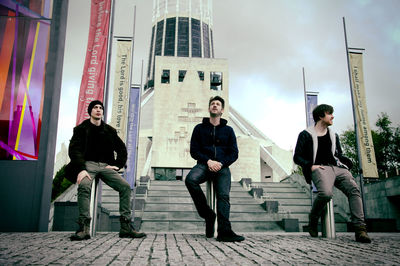 Full length of young man standing in city against sky