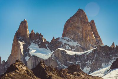 Panoramic view of rocky mountains against clear sky