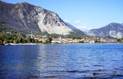 Scenic view of sea by buildings against sky