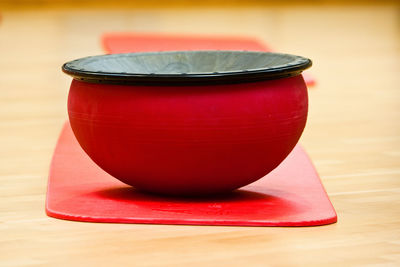 Close-up of red tea cup on table