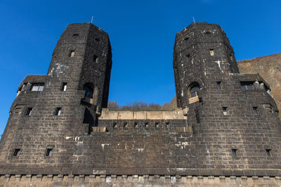Low angle view of historic building against blue sky