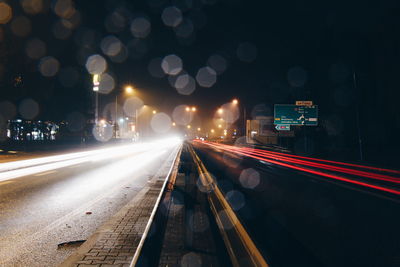 Light trails on road in city at night