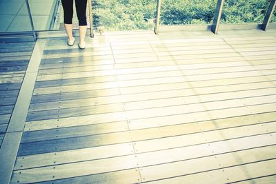 Low section of people standing on tiled floor