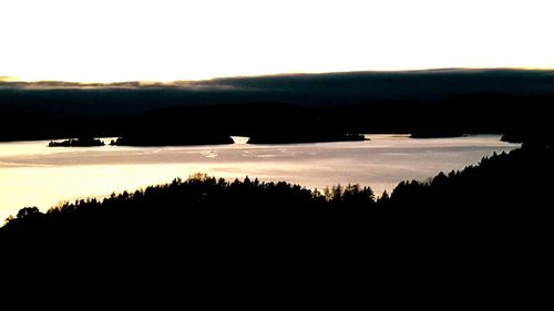 Scenic view of silhouette landscape against sky at sunset
