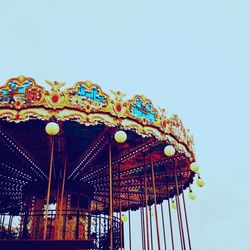 Low angle view of ferris wheel against blue sky