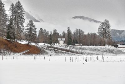 Scenic view of snow covered field against sky