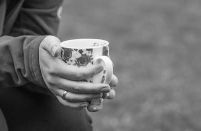 Cropped image of woman holding coffee cup