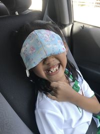 Portrait of happy girl in car