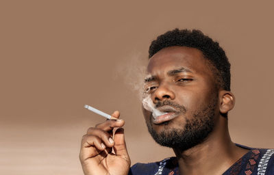 Portrait of man smoking cigarette