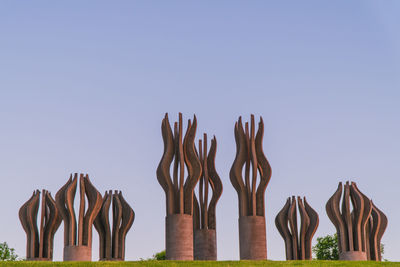 Low angle view of statues against clear sky