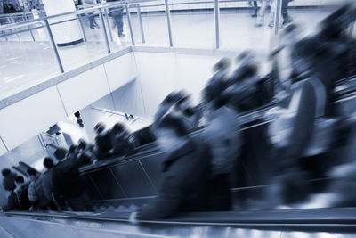 High angle view of people walking on escalator