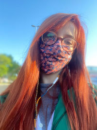 Portrait of woman with hair against sky