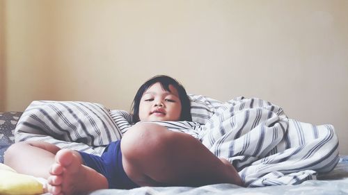 Portrait of girl lying on bed