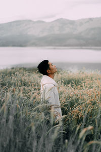 Side view of man standing on field