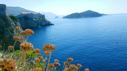 Scenic view of sea and mountains against sky