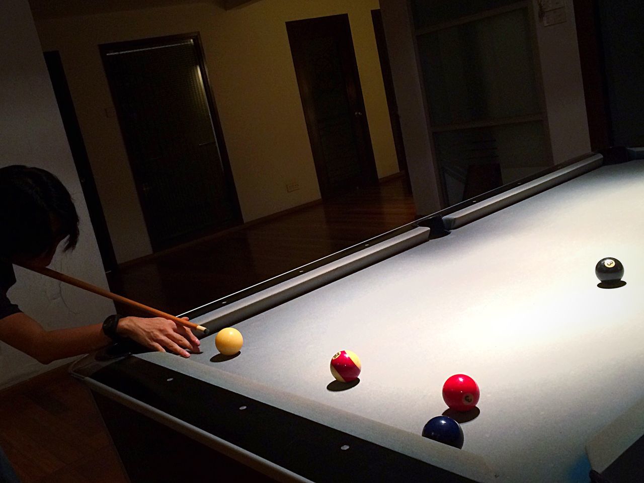 playing, leisure activity, one person, indoors, sport, lifestyles, human body part, people, human hand, adult, adults only, one man only, pool cue, pool - cue sport, pool table, pool ball, only men, men, night, snooker ball, snooker, cue ball