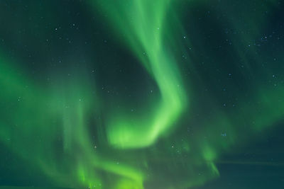 Aerial view of illuminated landscape against sky at night