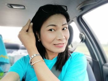 Portrait of smiling woman sitting in car