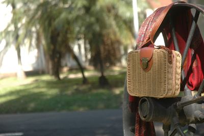 Close-up of wicker basket on road in city