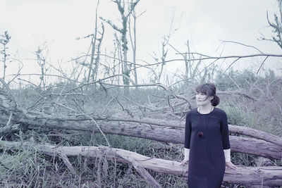 Portrait of woman standing on tree