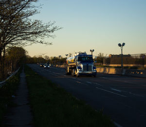 Road by city against clear sky