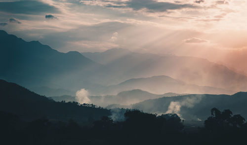 Scenic view of silhouette mountains against sky