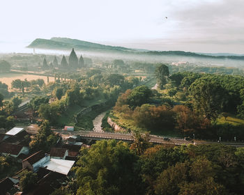 High angle view of trees and buildings against sky