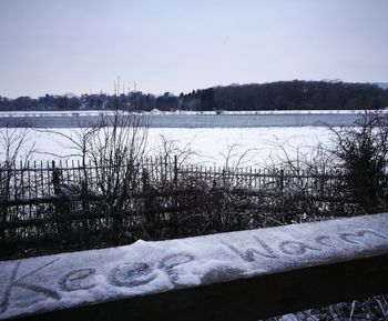 Scenic view of frozen lake against sky during winter