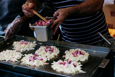 Midsection of man preparing food in kitchen