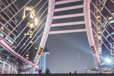 Low angle view of illuminated skyscraper against sky at night