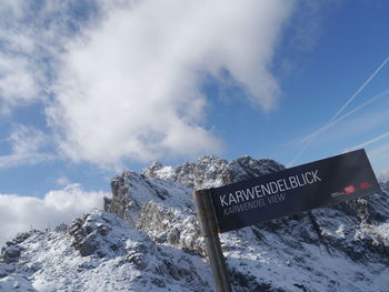 Text on snow covered mountain against sky