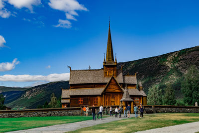 Group of people in front of building against sky