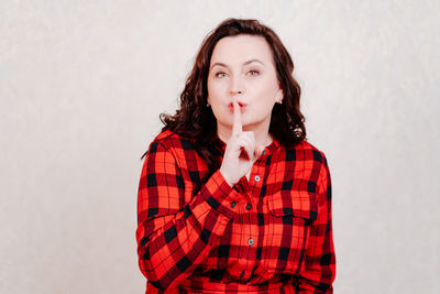 Portrait of beautiful young woman against white background