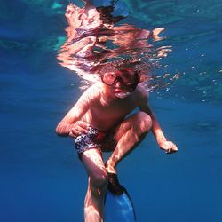 High angle view of shirtless man swimming in pool