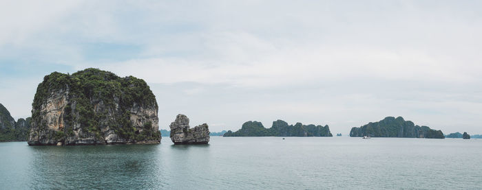 Rock formations in sea against sky