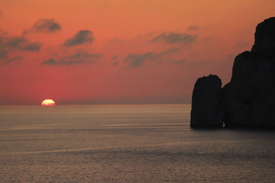 Scenic view of sea against orange sky