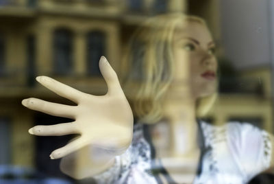 Close-up of mannequin on window display at shop