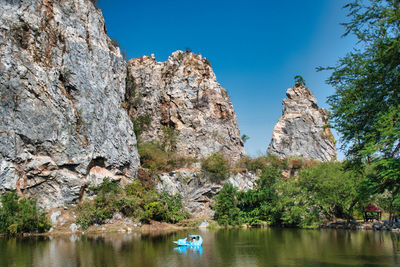 Scenic view of rocks and trees against clear sky