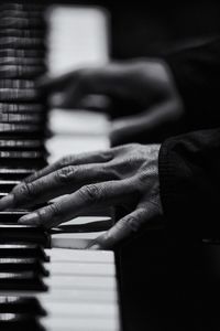 Cropped image of woman hands playing piano