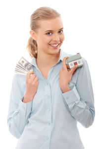 Portrait of a smiling young woman using phone